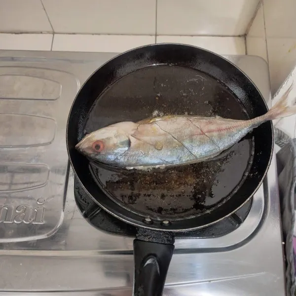 Goreng ikan dalam minyak panas.