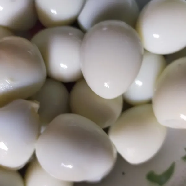 Kupas telur puyuh dan siapkan panci kukus. Olesi panci kukus dengan minyak goreng agar ekado tidak lengket di panci.