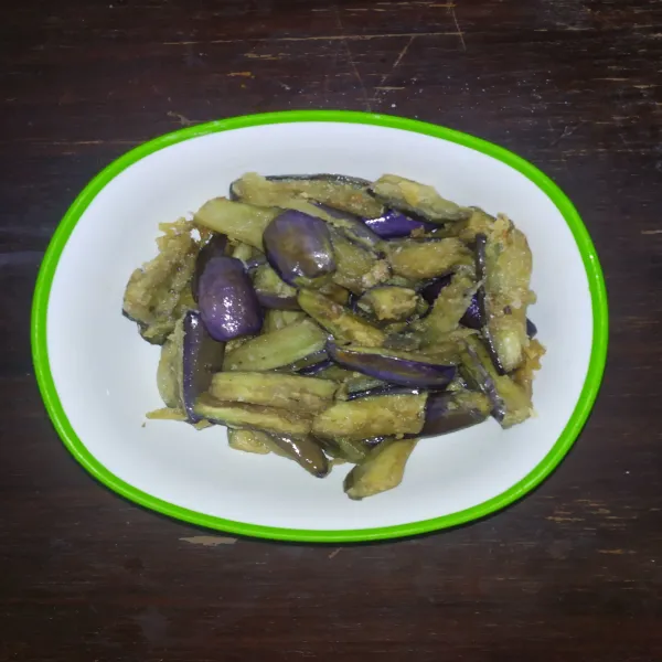 Lumuri terong dengan tepung bumbu, kemudian goreng. Lalu sisihkan.