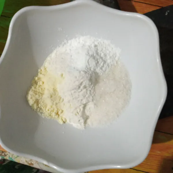 Campurkan tepung terigu, tepung beras, gula pasir, susu bubuk, garam, dan vanili bubuk. Aduk rata.