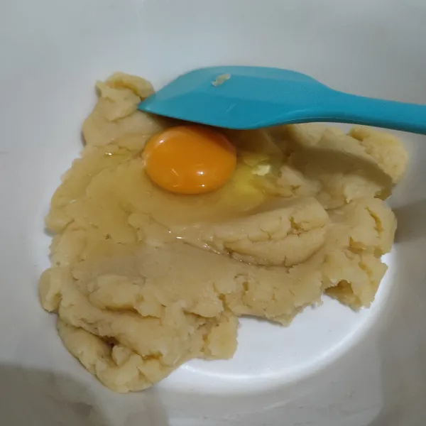 Setelah dingin, masukkan telur satu persatu dan aduk hingga tercampur rata, lalu bagi menjadi 2 bagian yang sama banyak, masukkan dalam piping bag.