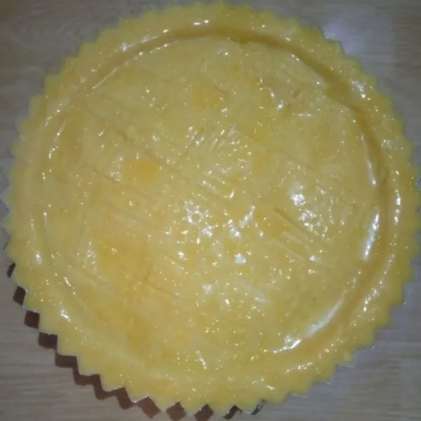Tutup dengan sisa bahan crust, oles atasnya dengan kuning telur, bikin motif dengan garpu, taburi sedikit gula pasir.