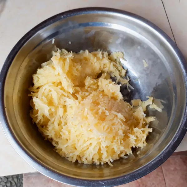 Kupas dan cuci bersih kentang. Rebus hingga setengah matang (10 menit). Tiriskan, parut dengan parutan keju.