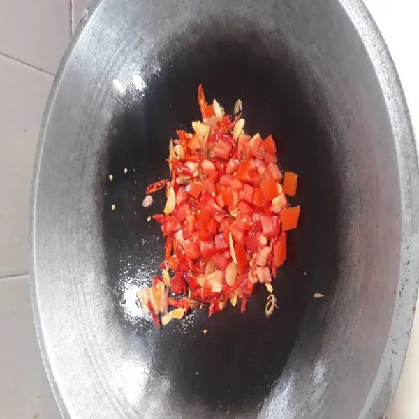 Tumis bawang merah dan bawang putih, setelah harum masukkan cabe iris. Setelah layu masukkan tomat yang sudah dipotong kecil. Aduk-aduk.