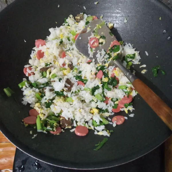 Masukkan nasi putih, aduk rata.