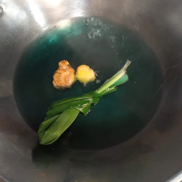 Dalam wajan, masukkan larutan bunga telang, tambahkan jahe dan daun salam.