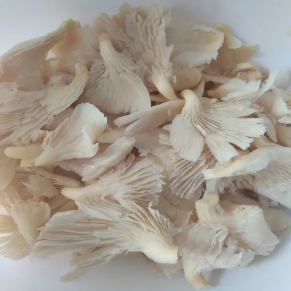Siapkan jamur tiram yang telah dicuci bersih, diperas, dan disuwir-suwir.