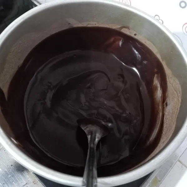 Campur bahan custard chocolate di panci, aduk rata, lalu masak di atas kompor sambil diaduk-aduk sampai kental dan meletup-letup, jika sudah matang biarkan panasnya hilang.