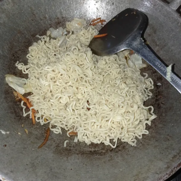 lalu masukan mi, aduk hingga tercampur rata, masak lagi sampai bumbu meresap, cek rasa