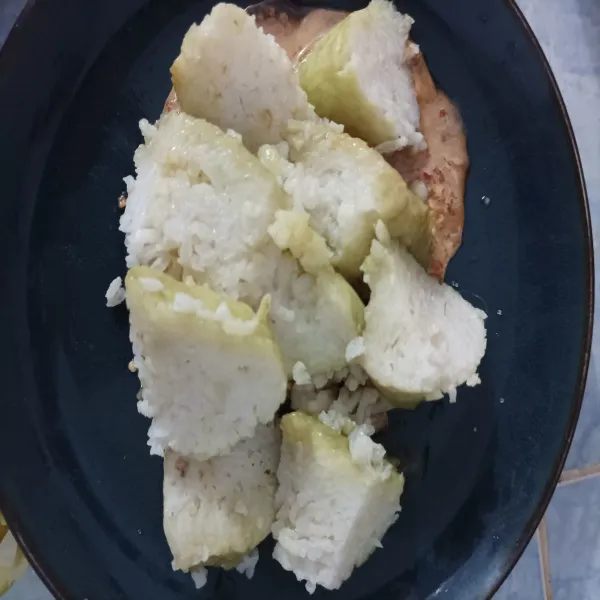 Iris lontong kemudian tuang kupang beserta kuahnya.
Sajikan dengan taburan bawang goreng.