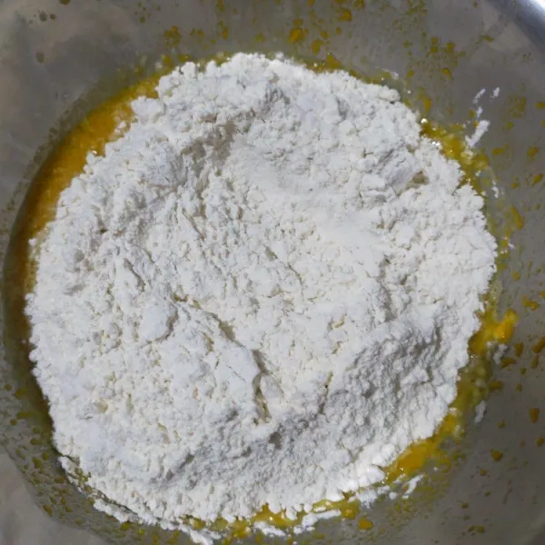 Masukkan tepung terigu dan garam. Aduk rata dengan sendok kayu/spatula. Setelah rata aduk-aduk selama 5 menit sampai adonan lembut.