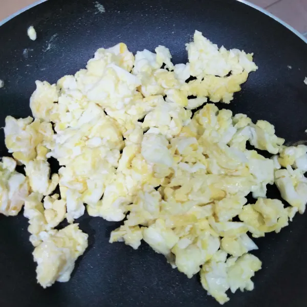 Lelehkan margarin, masukkan telur, beri bumbu, lalu orak-arik dan sisihkan.