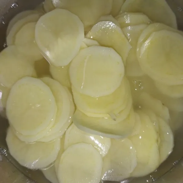 Siapkan kentang, pilih kentang yang agak kecil, agar mudah diserut. Lalu kupas kentang, kemudian potong tipis atau menggunakan serutan.