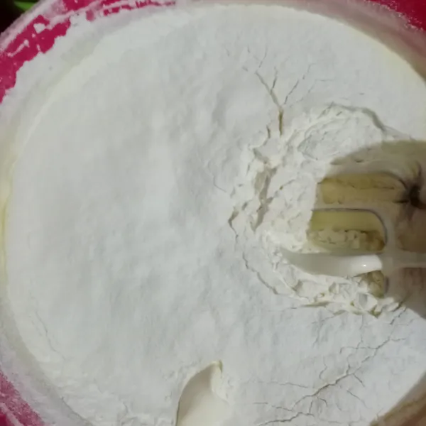 Masukkan tepung terigu dan garam sambil diayak. Mixer sebentar saja dengan kecepatan paling rendah.