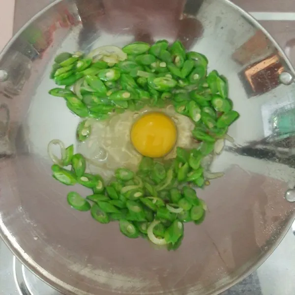 Kemudian masukkan telur, lalu kocok-kocok hingga tercampur rata.