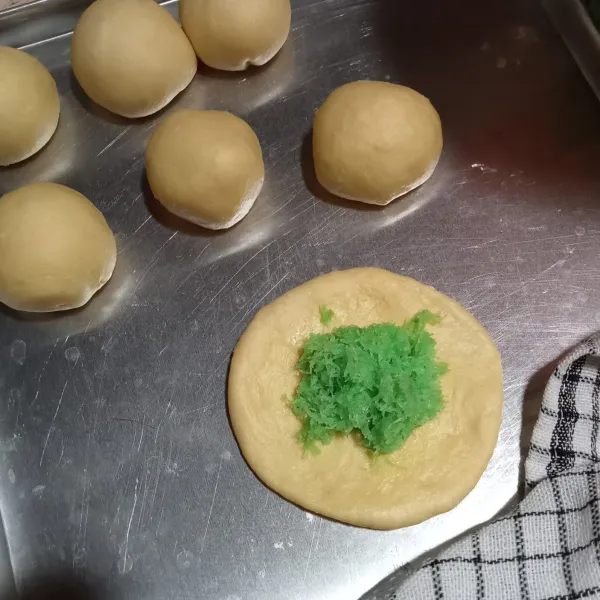 Pipihkan adonan, beri isian secukupnya. Bulatkan dan pipihkan adonan, kerat adonan tidak putus. Buat garis segitiga 8 garis. Pilin tiap potongan berlawanan arah.