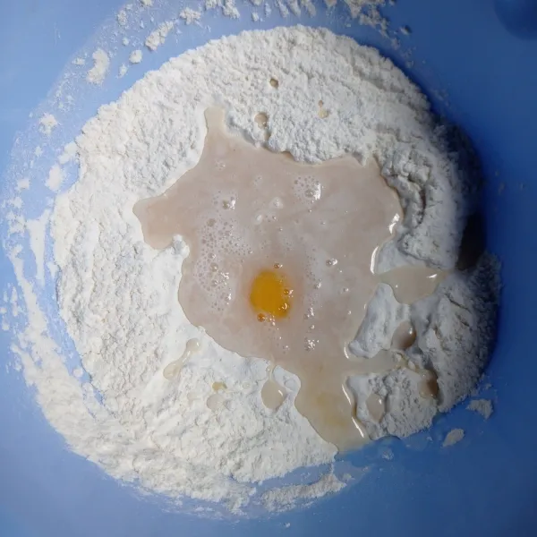 Campur tepung terigu, gula, ragi, dan susu bubuk, lalu aduk rata. Tambahkan air dan telur, aduk kembali sampai rata.