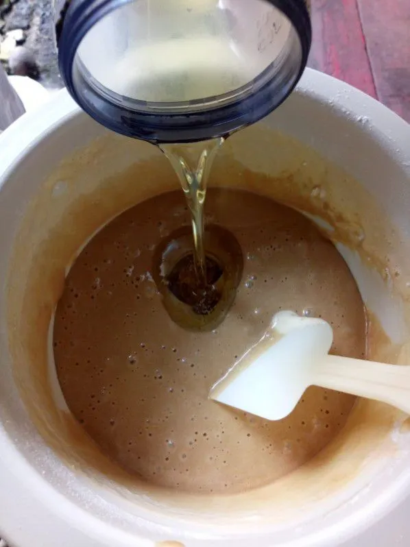 Masukkan bertahap air, gula merah, tepung terigu, lalu mixer dengan kecepatan rendah asal tercampur saja. Lalu masukkan minyak sedikit demi sedikit, aduk balik dengan spatula. Aduk sampai tidak ada minyak yang mengendap di bawah adonan.