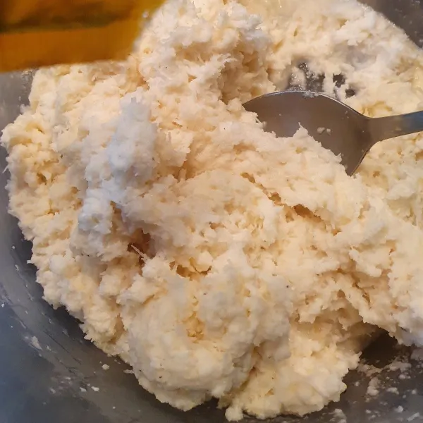 Dalam wadah bersih, masukkan singkong dan kelapa parut. Tambahkan gula pasir, Masukkan garam, aduk rata.