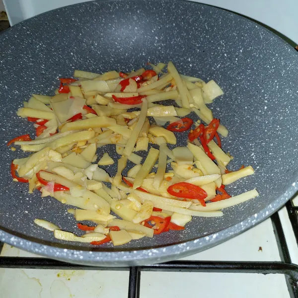 Masukkan rebung, lalu aduk rata.