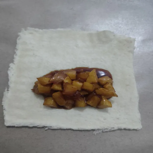 Siapkan roti tawar, potong pinggirannya, lalu pipihkan.