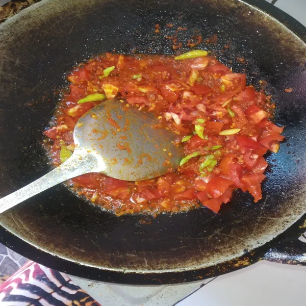 Masukkan irisan tomat dan serai, lalu aduk merata hingga tomat layu.