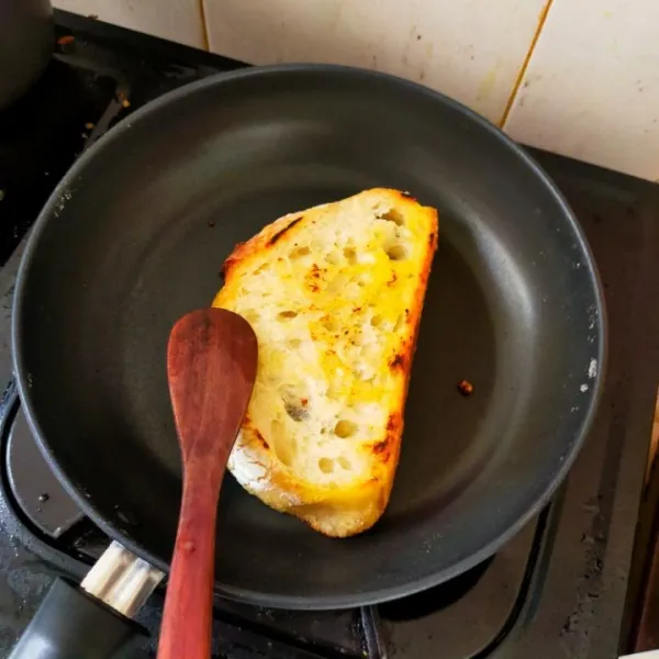 Panaskan margarin. Panggang sourdough bread hingga kedua sisinya kering.