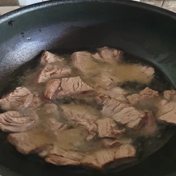 Panaskan minyak, goreng daging hingga setengah kering. Angkat dan tiriskan.