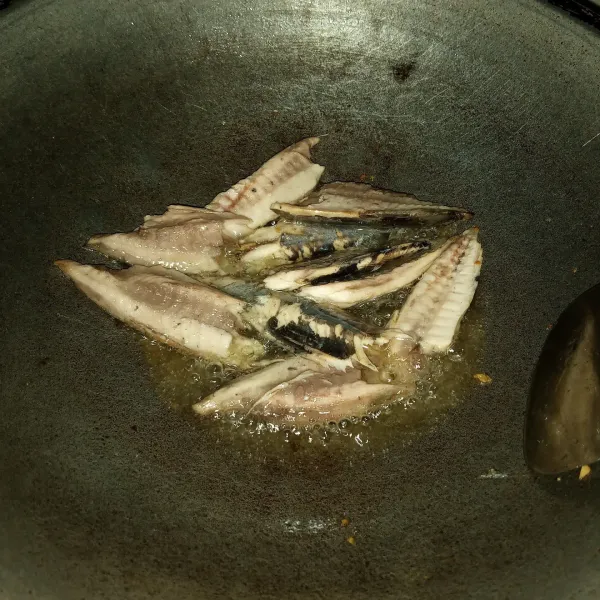 Goreng ikan sampai matang, lalu tiriskan.