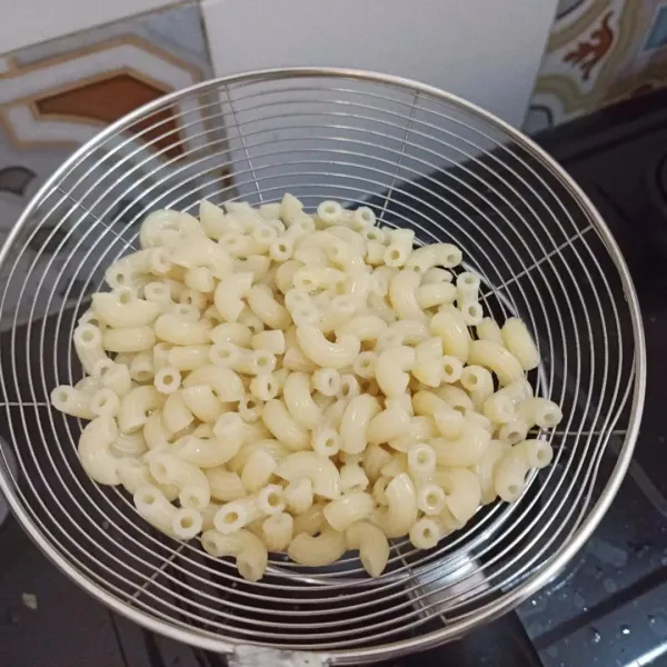 Rebus macaroni setengah matang, beri sedikit garam. Tiriskan, beri 1 sdm minyak, aduk rata.