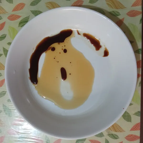 Siapkan piring saji, masukkan minyak wijen, kecap ikan, dan kecap asin.