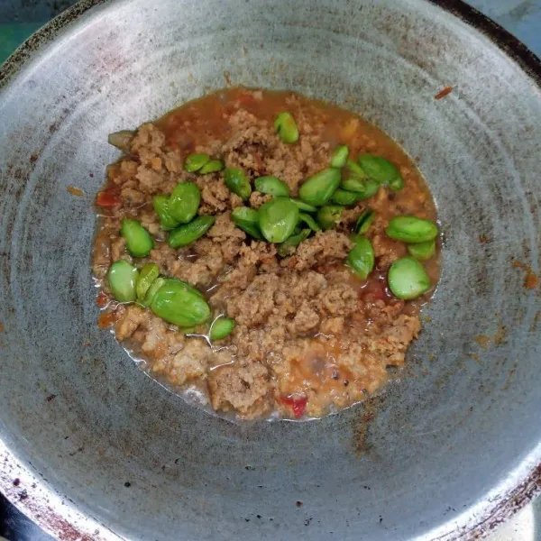 Masukkan oncom dan petai, aduk rata. Masak sampai sambal meresap.