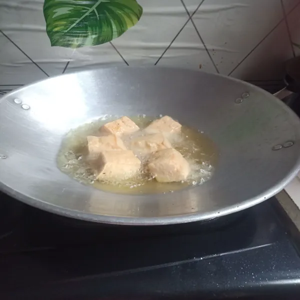Panaskan minyak, goreng tahu hingga berkulit dan sisihkan.