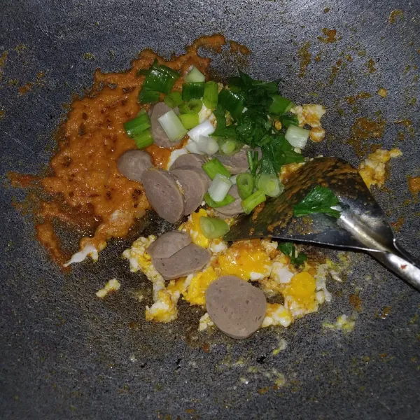 Masukkan bakso, daun bawang, dan daun seledri, lalu aduk rata dan tambahkan air.