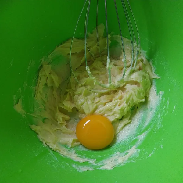 Kocok telur dan gula halus hingga rata. Selanjutnya masukkan kuning telur aduk rata kembali.