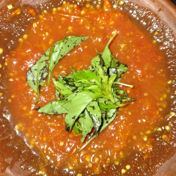 Masukkan daun kemangi, lalu bejek-bejek hingga layu.