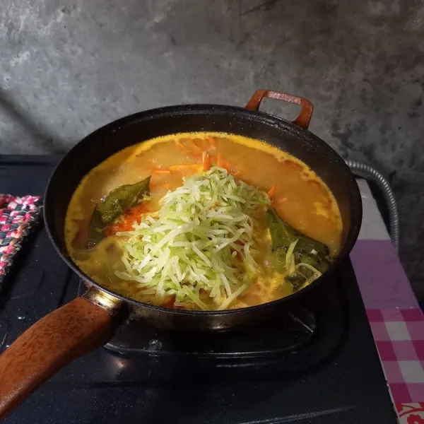 Selanjutnya masukkan air, wortel, labu siam, garam, gula pasir dan penyedap rasa. Masak sampai matang dan koreksi rasa.