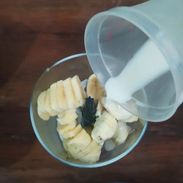 Blender pisang beku dan susu kedelai dingin hingga halus. (Susu kedelai bisa diganti dengan santan instan atau susu jika tidak sedang diet).
