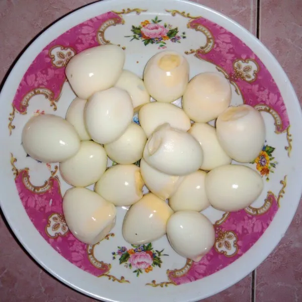 Rebus telur puyuh sampai matang lalu kupas kulitnya.