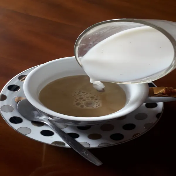 Masukan larutan susu cair kedalam cangkir yang telah diberi gula jawa cair.