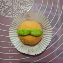 Bulatkan adonan, kemudian letakkan di cup/ kertas roti. Beri daun-daunan.