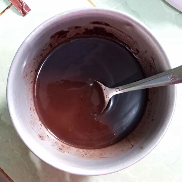 Lelehkan dcc, lalu tuang minyak dan krimer kental manis cokelat, aduk rata, biarkan hangat.