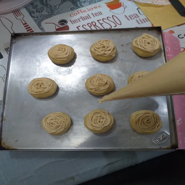 Masukkan di plastik segi tiga hias atas roti dengan topping