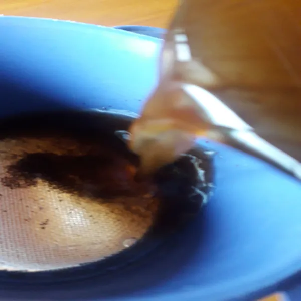 Saring kopi yang telah didiamkan kedalam gelas saji.