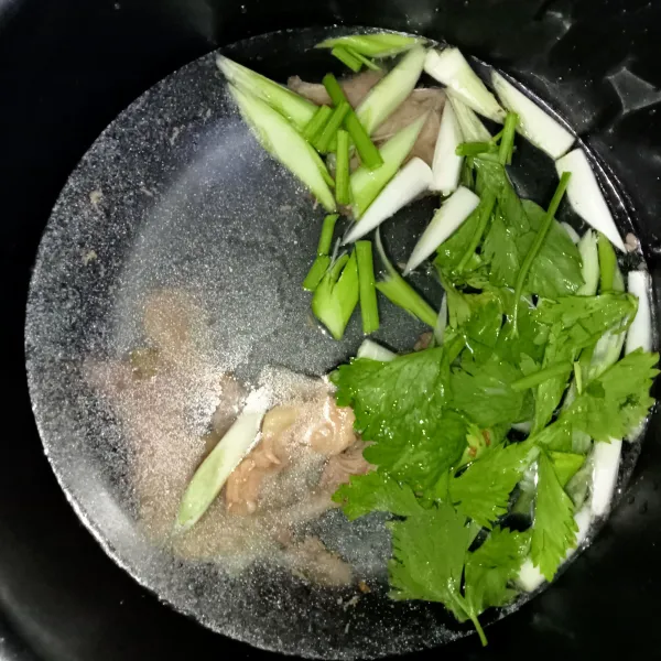 Dalam panci masukkan tulang sapi, tambahkan air hingga menutupi tulang lalu masukkan potongan daun bawang prei dan seledri.