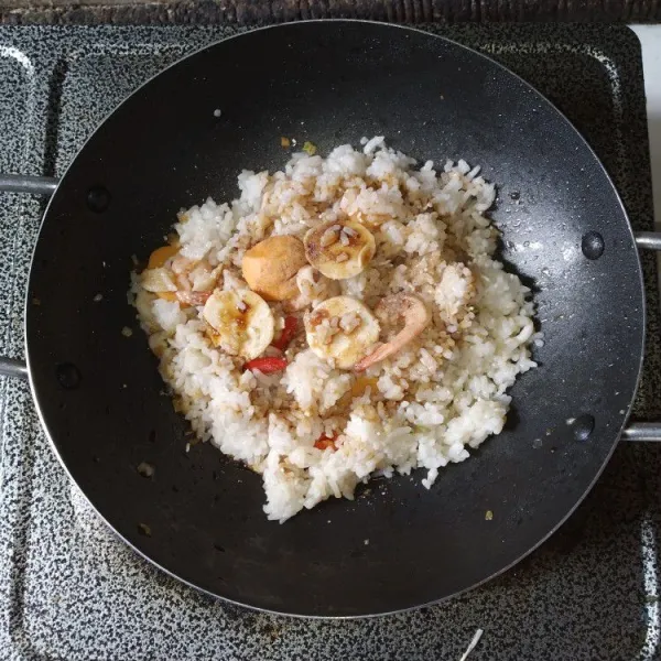 Tambahkan nasi putih, masukkan bumbu-bumbu aduk rata.