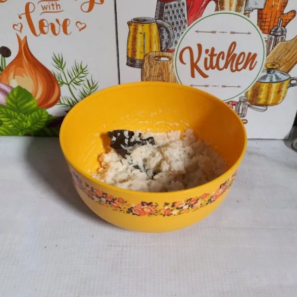 Masukkan ketan kukus ke dalam bowl. Masukkan santan, garam, dan daun salam. Diamkan selama 5 menit agar santan meresap.