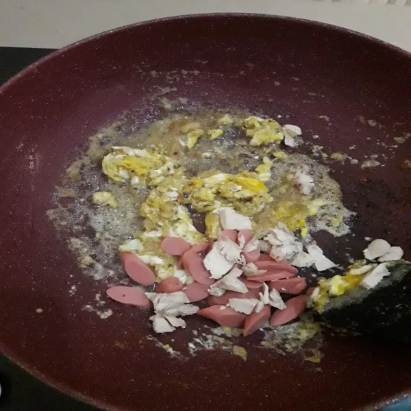 Masukkan telur, orak-arik sebentar. 
Tambahkan sosis dan irisan ayam. 
Aduk sebentar.