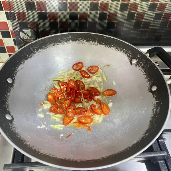 Panaskan minyak kemudian tumis bawang putih, ½ potongan serai dan cabai merah hingga harum.
