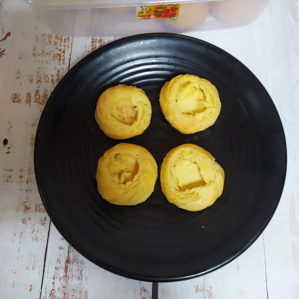 Buat lubang di atas kue sus, potongannya bisa dimasukkan ke dalam kue sus.